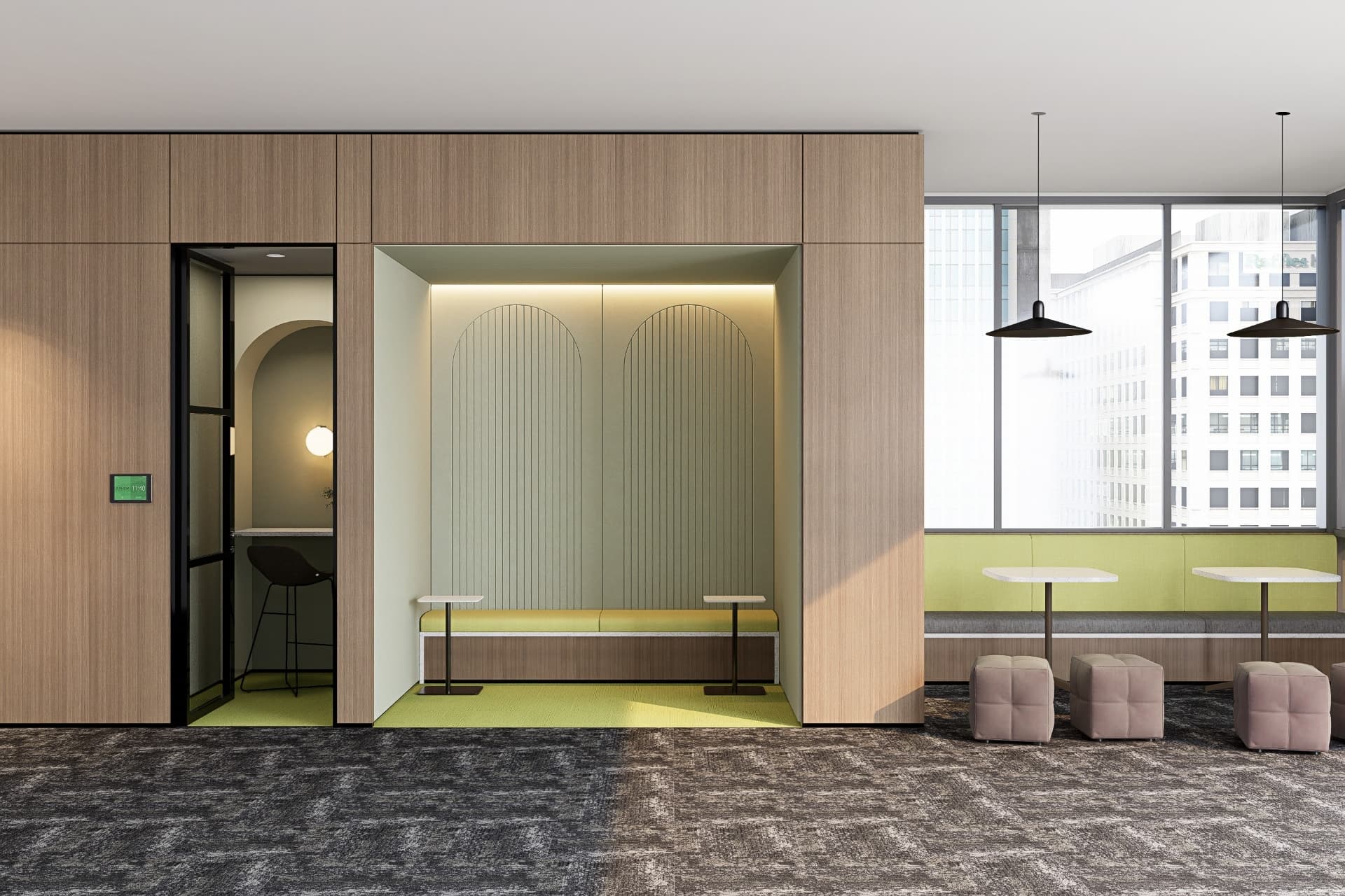 A modern office space features a small room with a single barstool and light fixtures behind a sleek black-framed glass door. Adjacent to it is a light green seating alcove with two white tables and cushioned stools, while arch acoustic felt wall panels enhance the design. Large windows provide ample natural light.