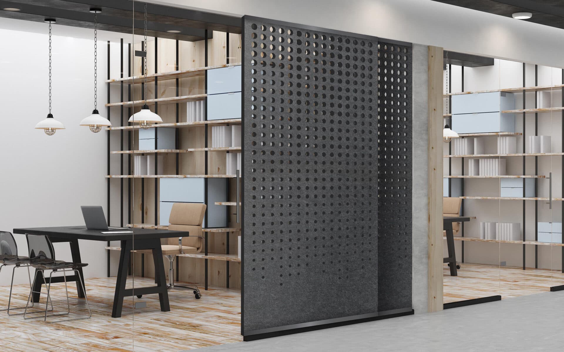 Modern office space with a minimalist design. The room features open shelves filled with books, a grey sliding acoustic felt screen with circular perforations, and a sleek black desk with a laptop. Two wooden chairs are positioned at the desk, complemented by pendant lights.