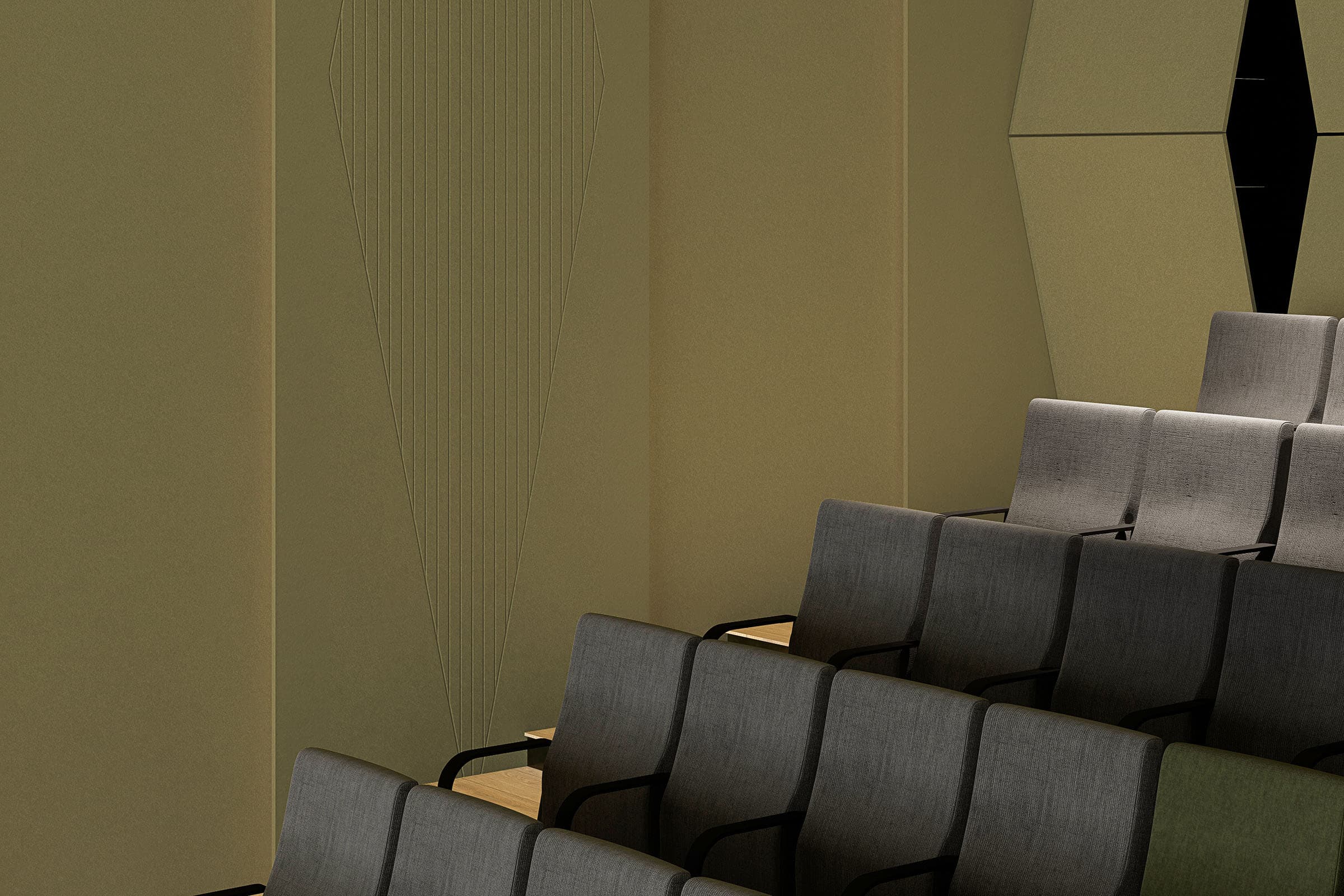 An interior view of a modern auditorium featuring several rows of gray cushioned seats with armrests. The walls are a combination of smooth and geometric acoustic felt paneling, contributing to a minimalist and contemporary feel. Soft lighting is evenly distributed, with pennants subtly accenting the decor.