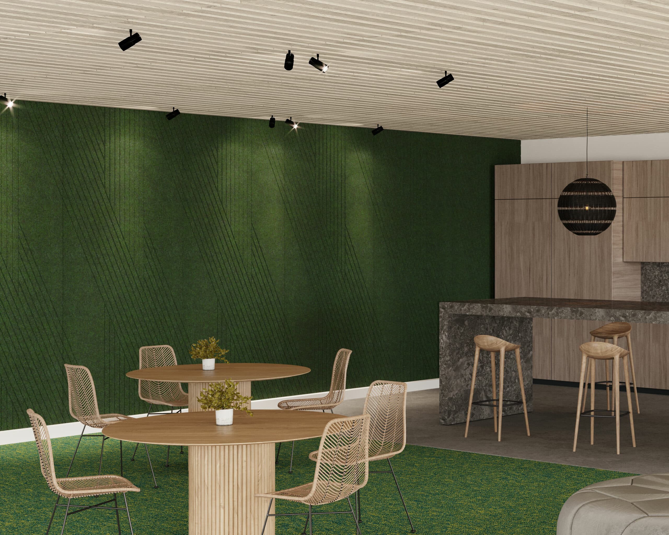 A modern lounge area featuring green textured walls, an acoustic felt wall panel, and a wooden round table with four mesh chairs. A bar with high stools is accompanied by potted plants on the table and bar top. Black suspended lights and a spherical pendant light hang from a wooden slatted ceiling.