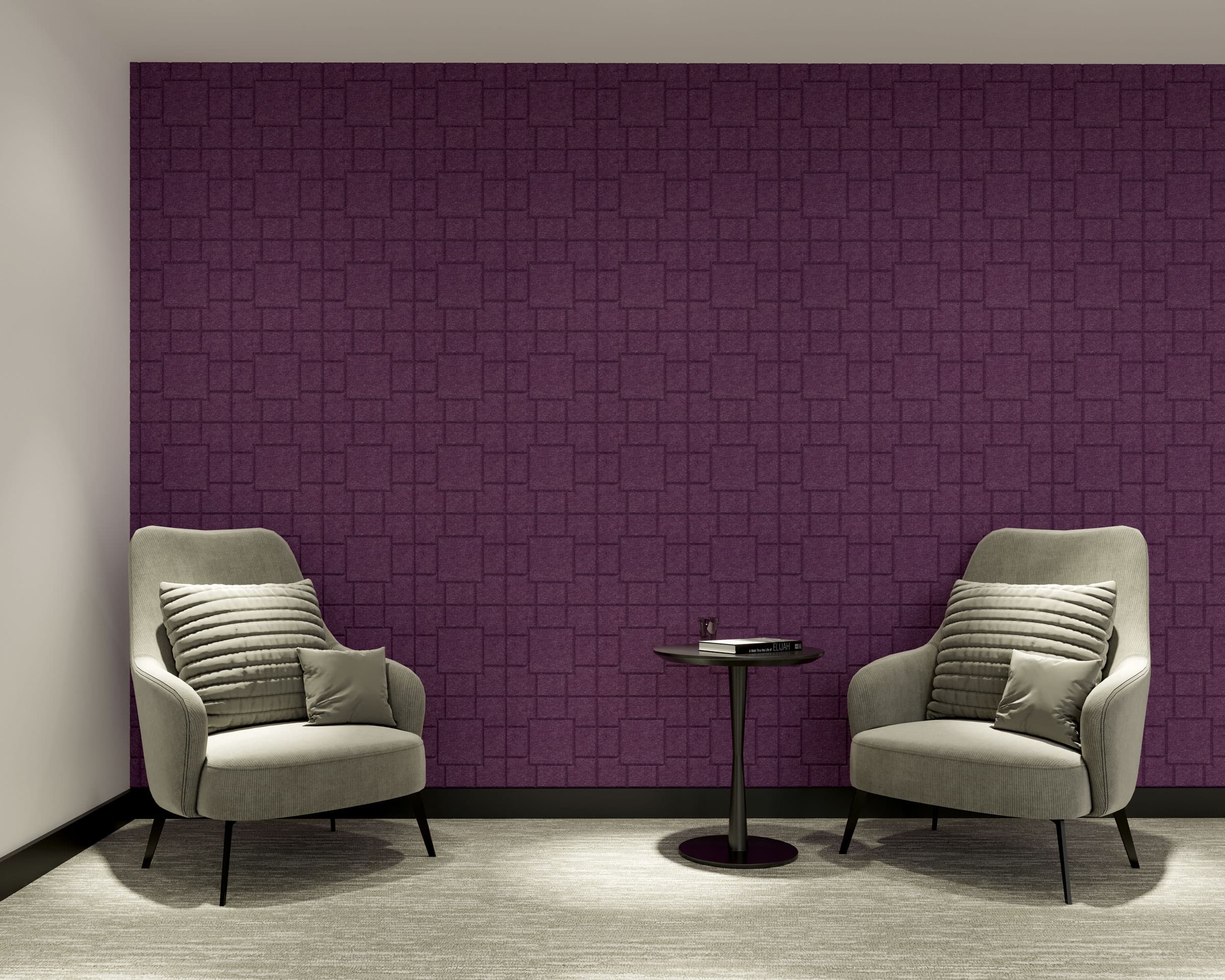 A modern living room features two light grey upholstered armchairs with curved backs and matching cushions, positioned on either side of a small, round black table. The background showcases deep purple acoustic felt wall tiles with a geometric texture, and the floor is carpeted in a light grey hue.