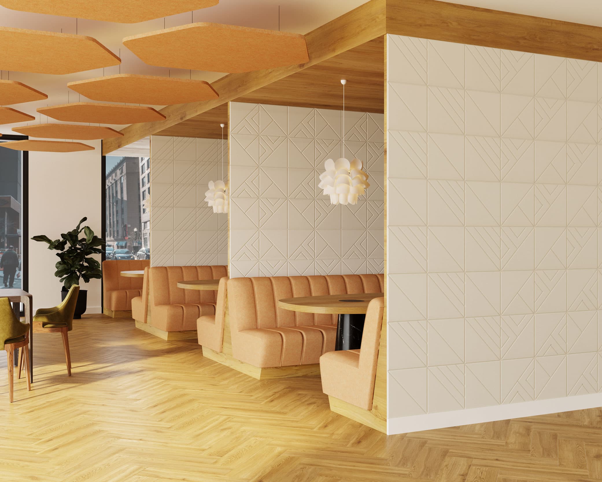 A modern café with herringbone hardwood floors. It features cozy booth seating upholstered in light brown fabric and tables with pendant lights shaped like white blossoms. Acoustic felt wall tiles add a touch of elegance while orange panels suspended from the ceiling enhance sound quality. A plant decorates the corner.