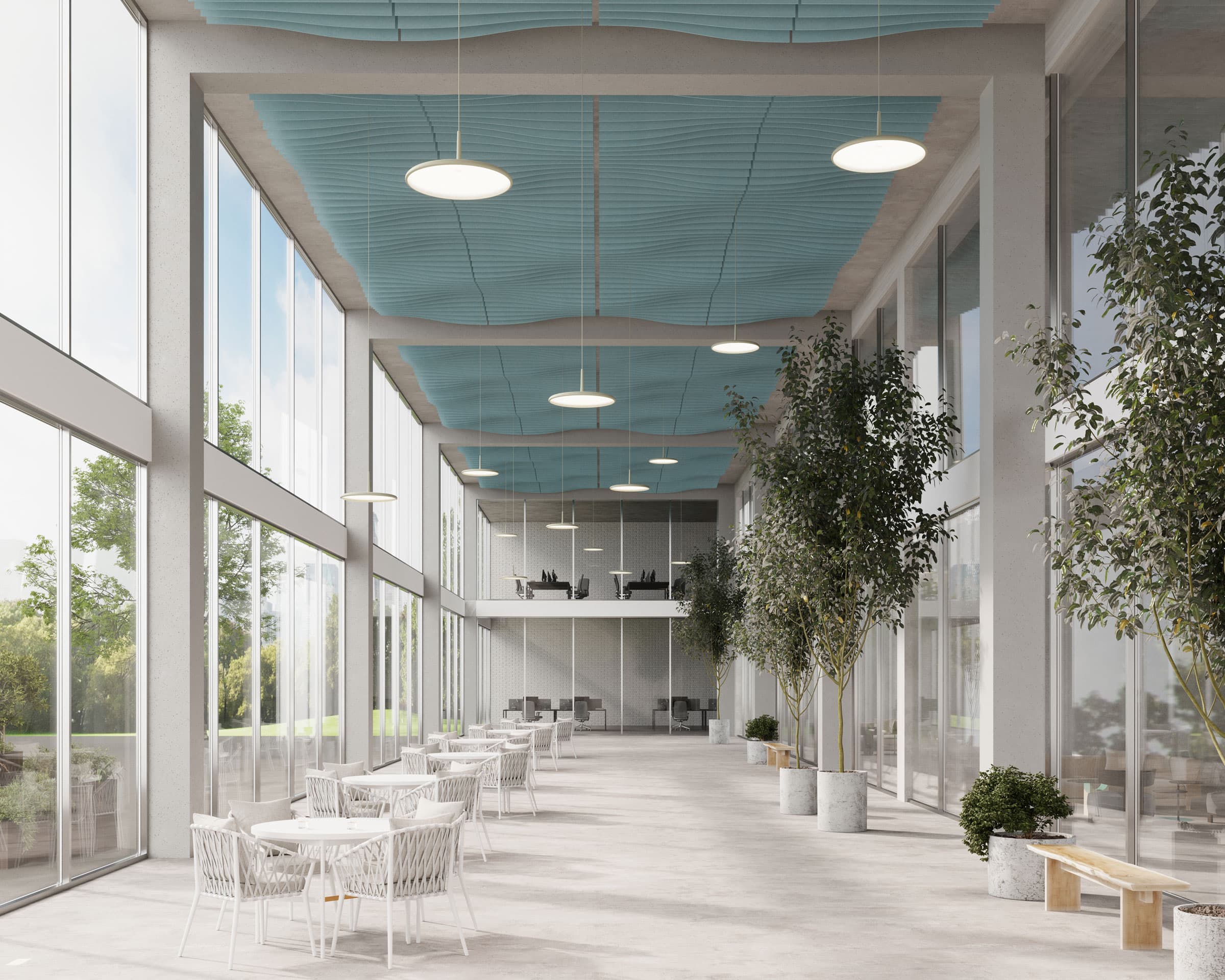 A spacious, modern office interior with large windows, white walls, and blue fan-patterned acoustic felt ceiling baffles. The area features small white tables and chairs, potted plants, and a mezzanine level with additional workspaces. Natural light fills the space.