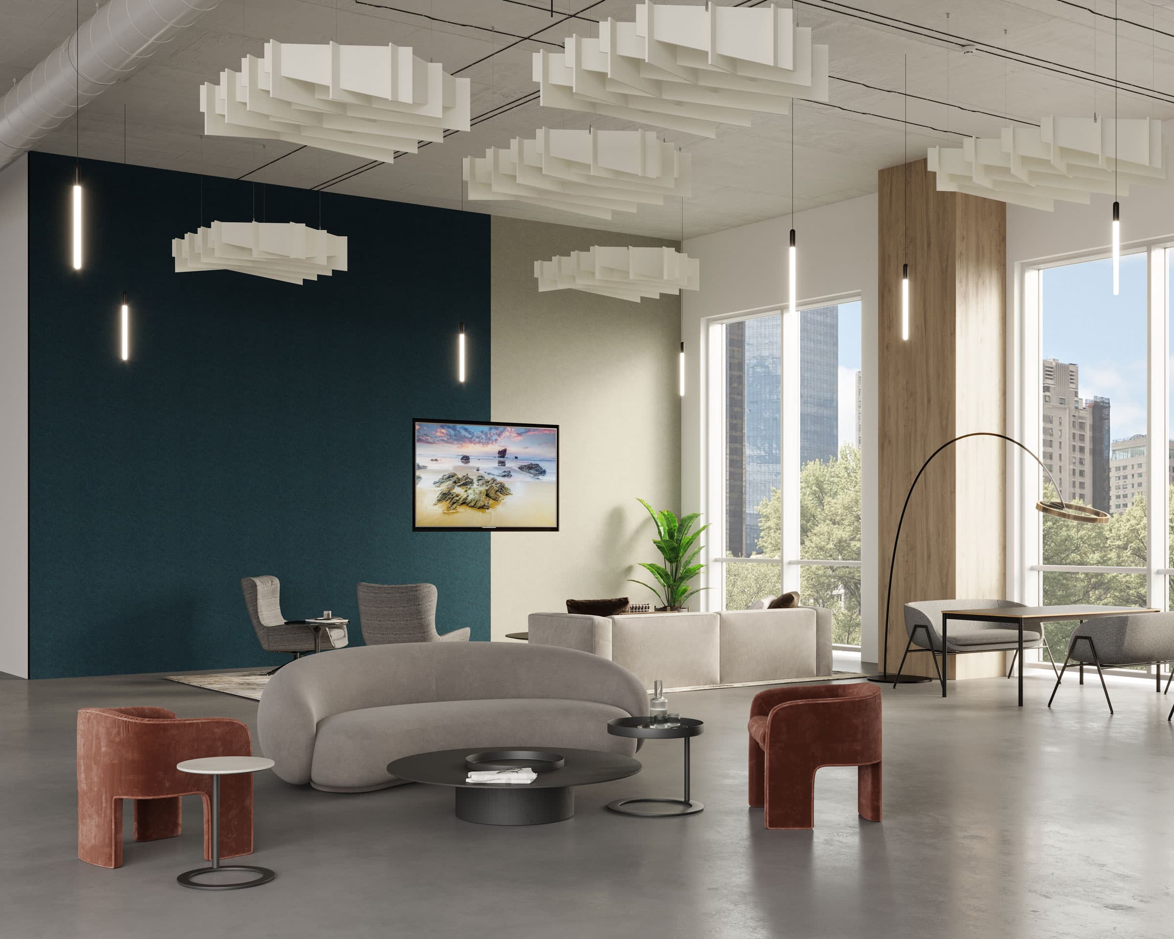 A modern, well-lit office lounge features a variety of stylish furniture, including a curved gray sofa, two red velvet chairs, and a circular black coffee table. Large windows offer a cityscape view while geometric acoustic felt ceiling clouds and a wall-mounted TV complete the space.