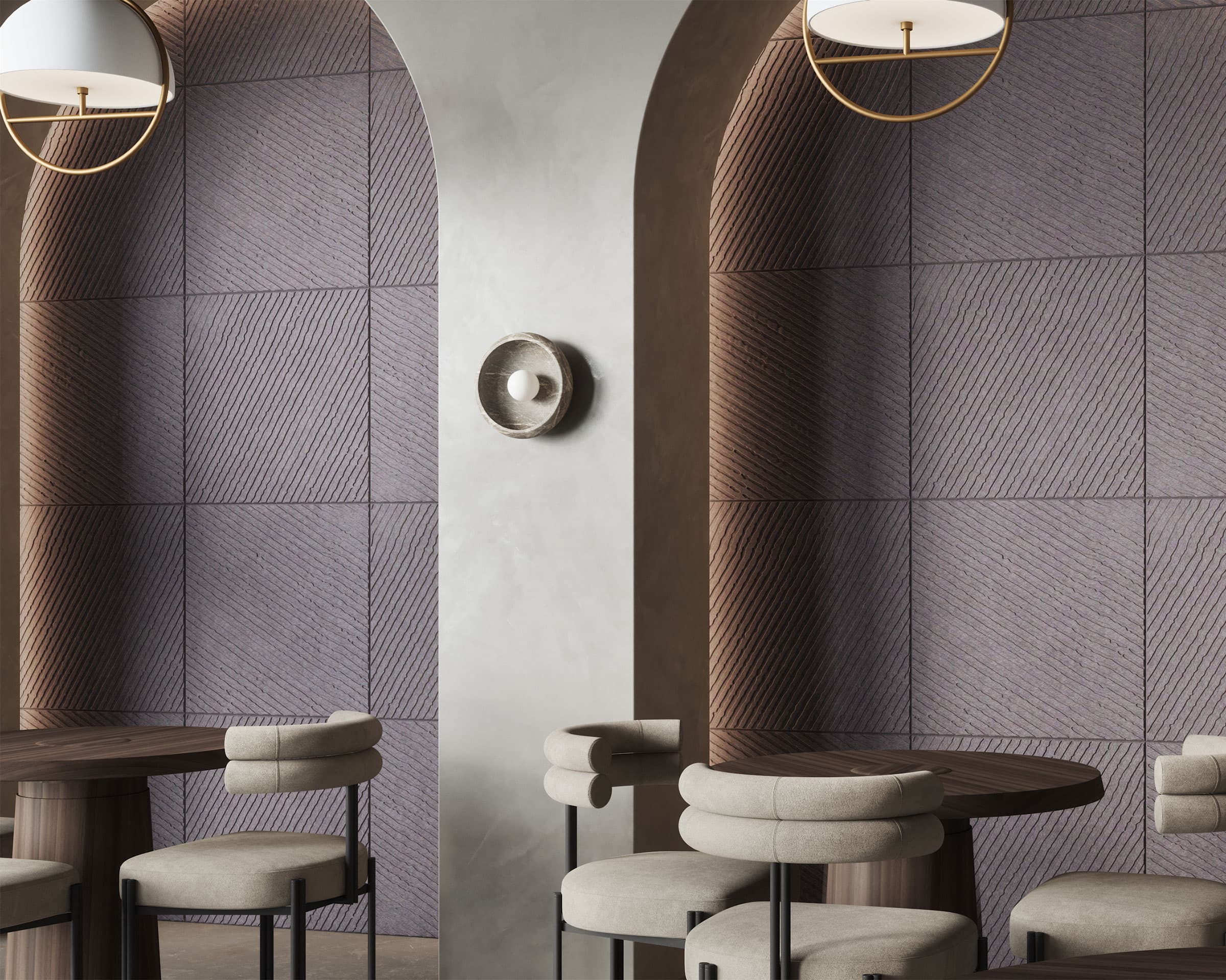 A modern interior features arched doorways, textured acoustic felt wall tiles, and round wooden tables with light gray cushioned chairs. Two hanging pendant lights with white shades provide illumination.