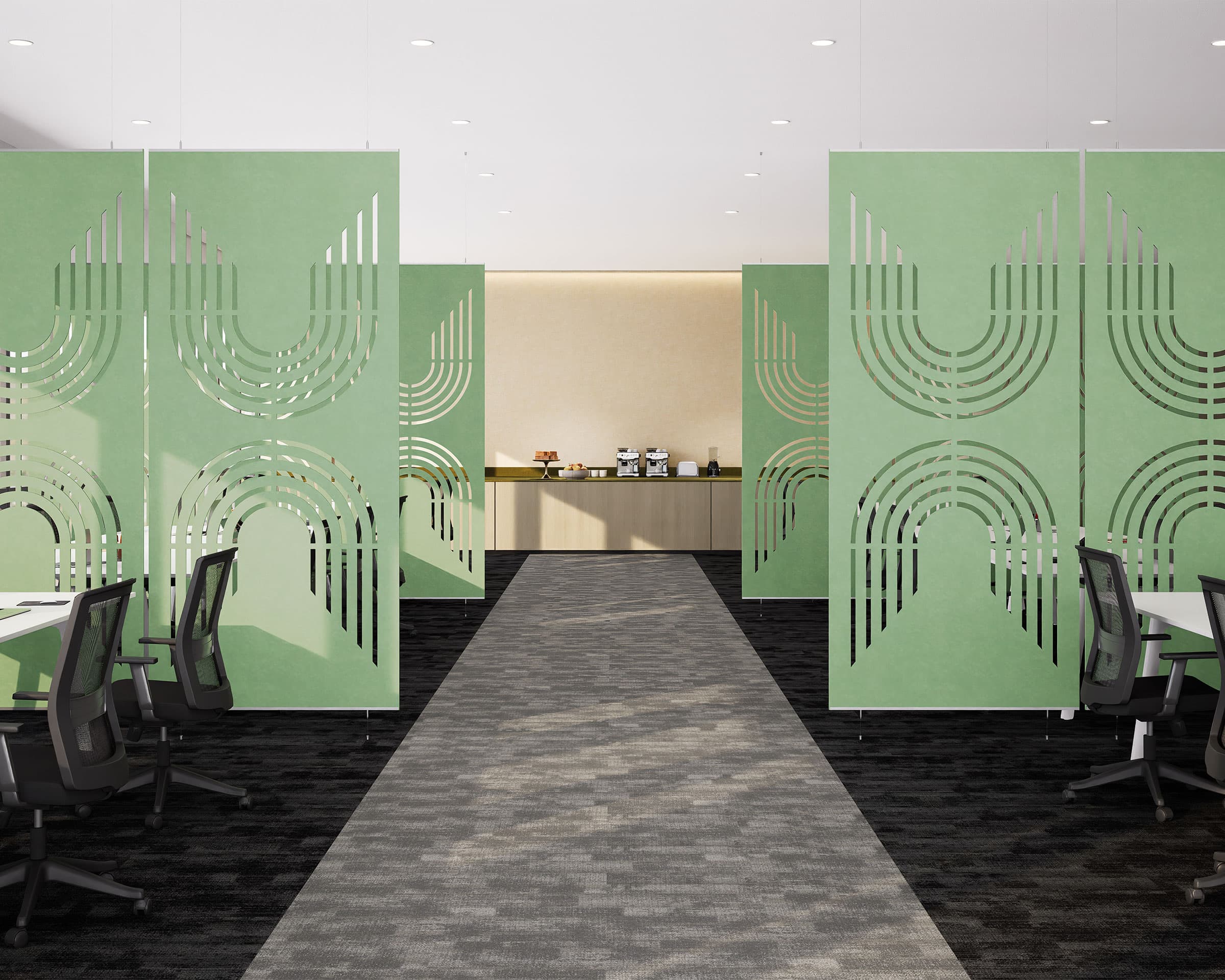 Modern office space featuring green acoustic felt screens with geometric cutout designs, a central walkway leading to a coffee station, and ergonomic office chairs around white desks on either side. The room is well-lit and has a clean, minimalist design.