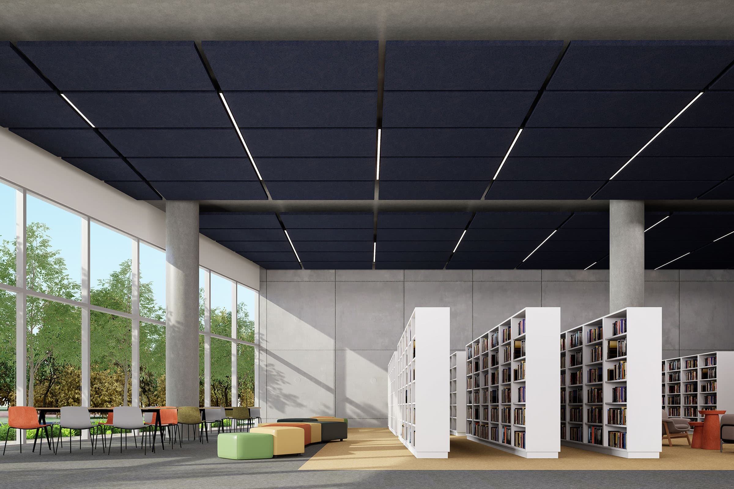 A modern library interior with large windows, allowing natural light to fill the space. The room features bookshelves filled with books, colorful seating arrangements, and study tables and chairs. The ceiling has sleek, dark acoustic felt ceiling clouds.