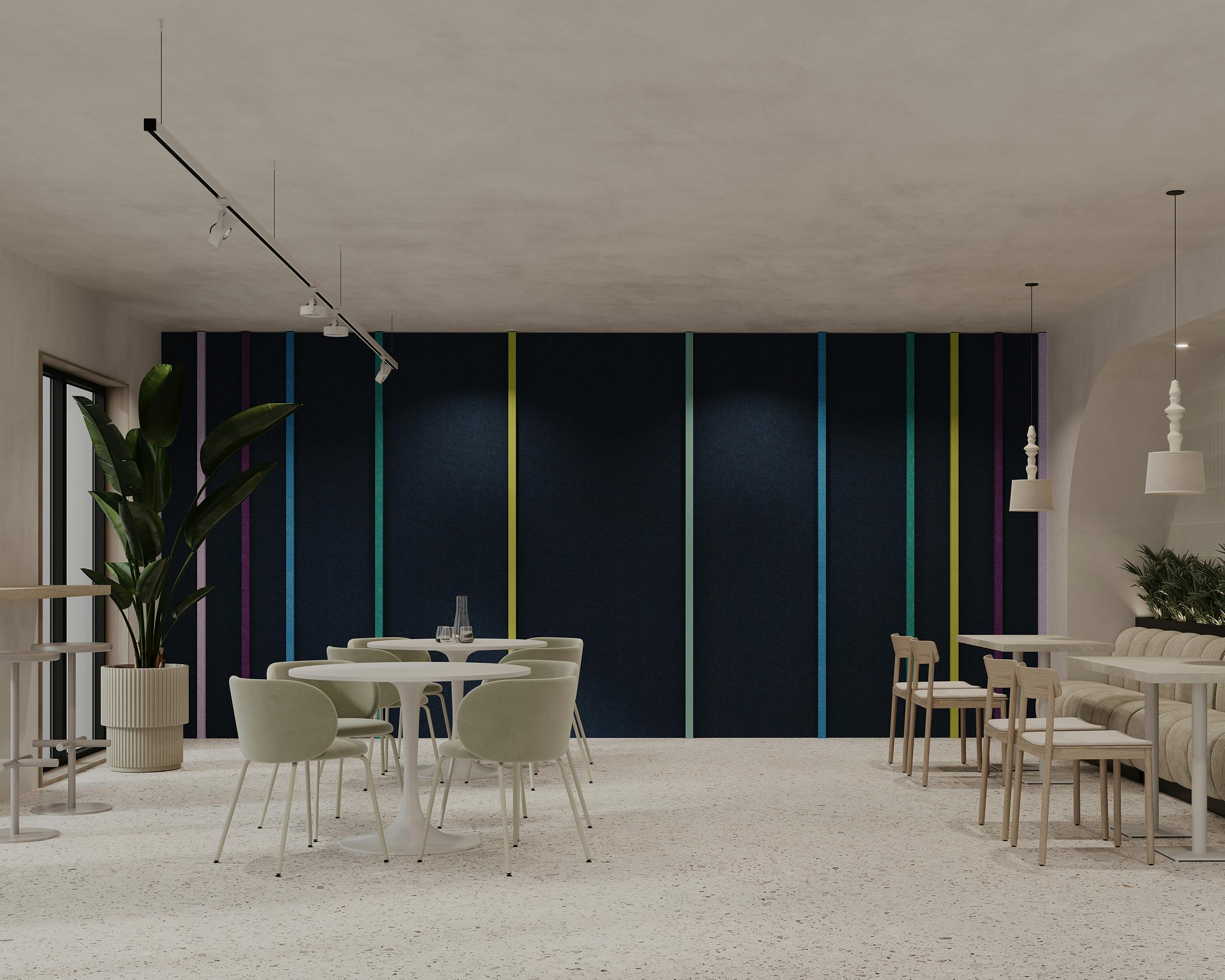 A modern, minimalist dining area with light-colored furniture, featuring a midnight blue acoustic felt wall accented with colorful vertical stripes. The seating includes green chairs around white tables, and beige chairs and a bench along the right wall. Potted plants add greenery.