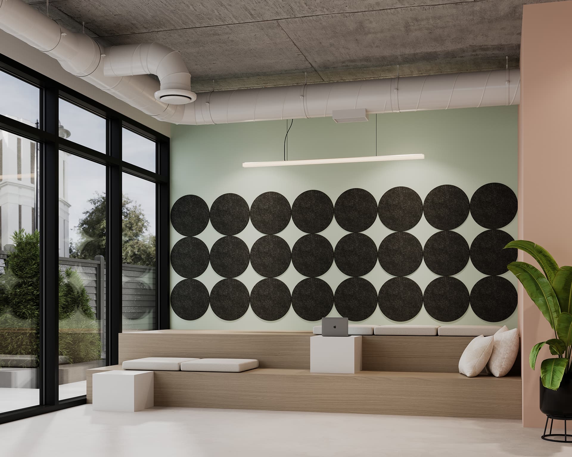 A modern, minimalist room with a light wood bench and gray cushions, a small white cube table, and a laptop. The wall features black circular acoustic felt tiles arranged in a grid. Large windows reveal an outdoor view, and a green plant is on the right side.