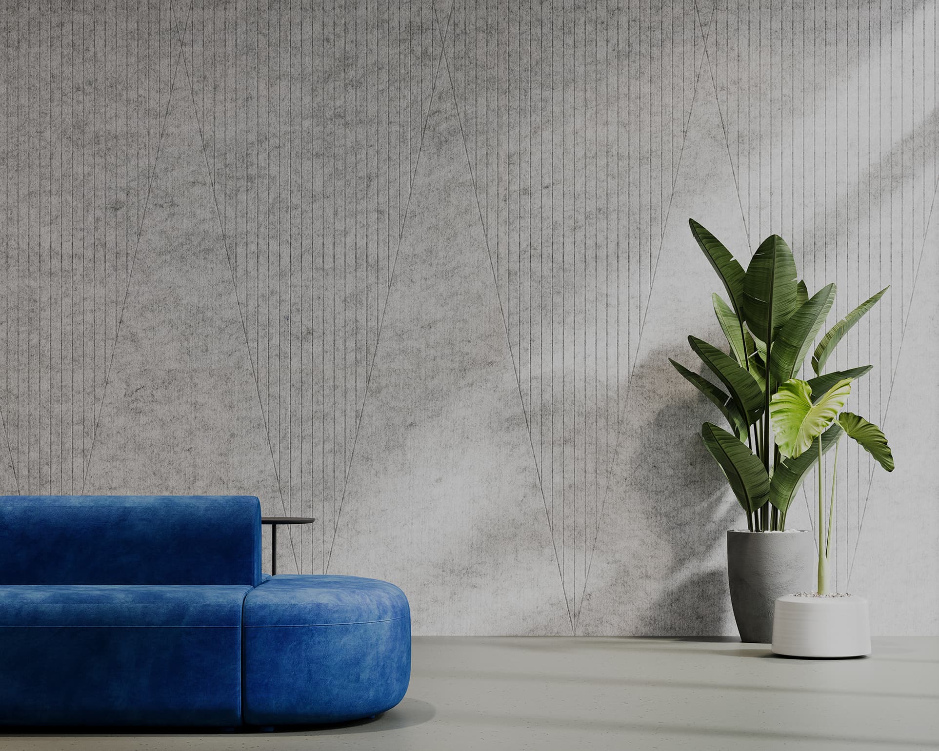 A modern living room featuring a vibrant blue sofa with a sleek design positioned against a light gray textured acoustic felt wall. To the right, there are two potted plants, one large with broad green leaves and the other smaller, both sitting on the floor. The setting is minimalist.