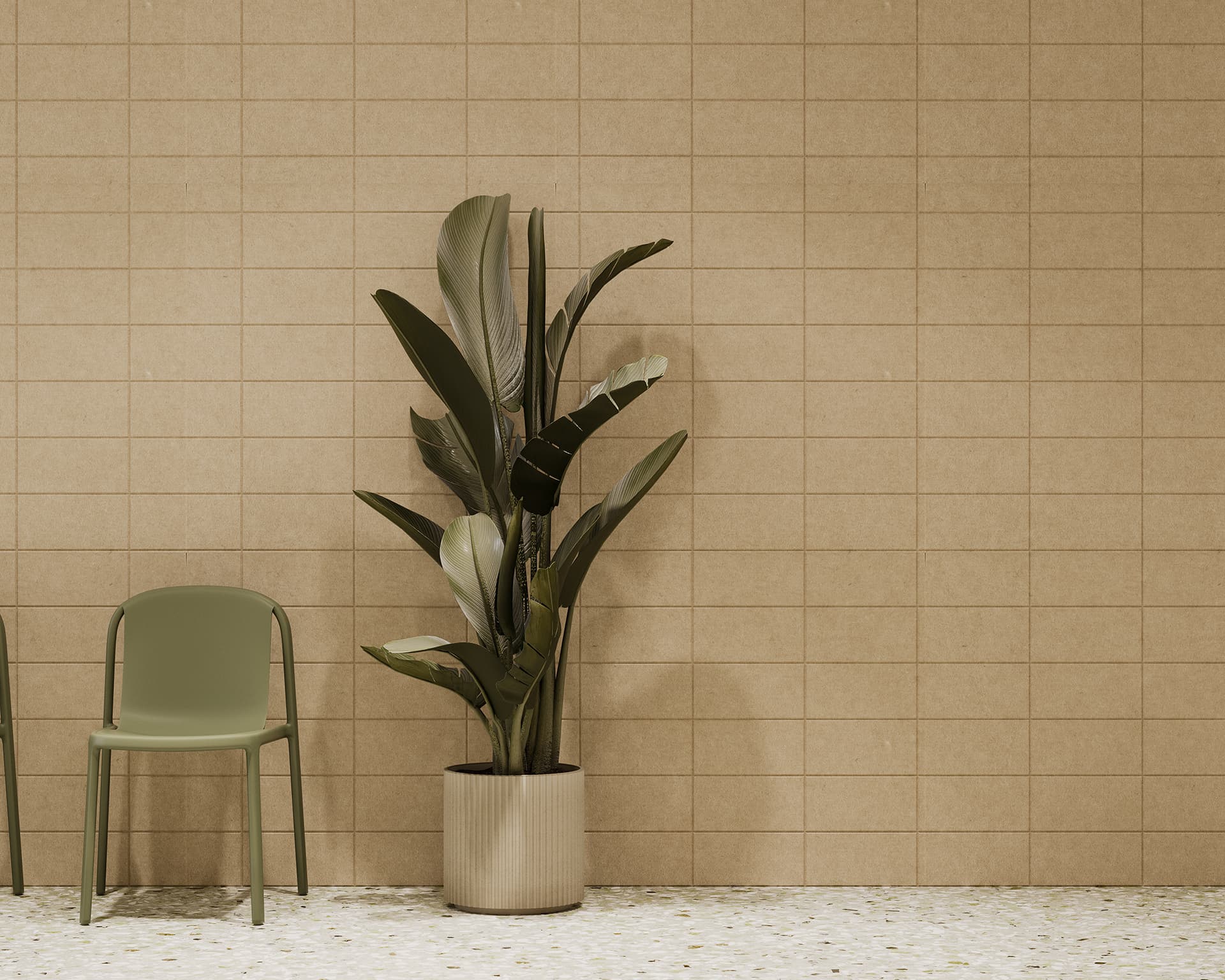 A minimalist room features a green chair and a tall potted plant with large leaves. The floor is speckled with a light-colored pattern, and the wall is covered in beige acoustic felt tiles arranged in a grid pattern. The overall color scheme is neutral and calming.