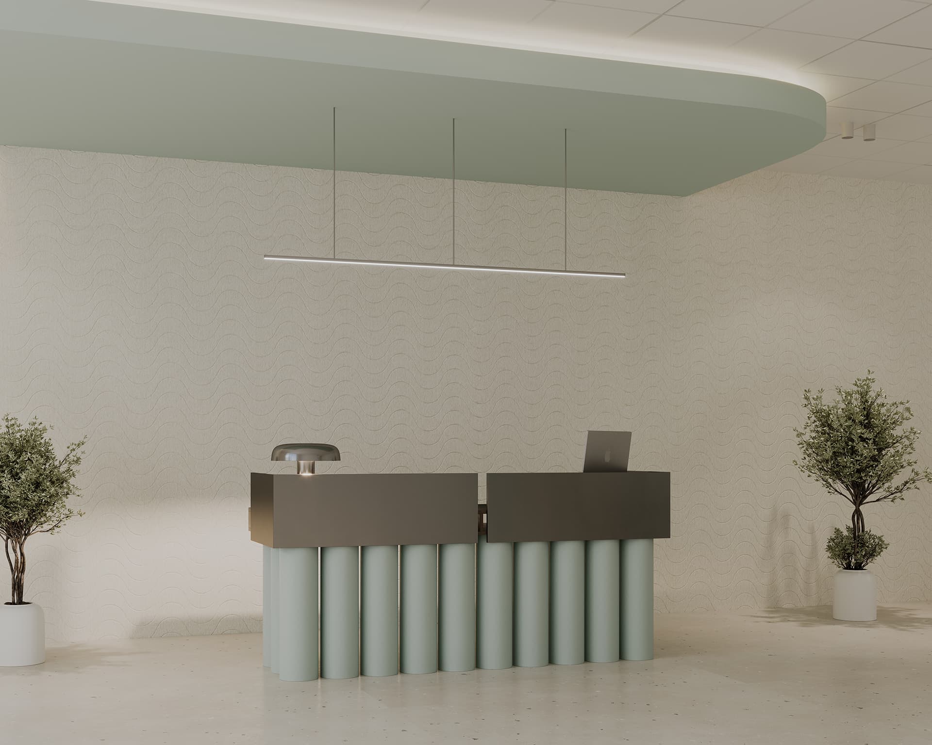 A minimalist reception area featuring a sleek, modern desk with cylindrical supports and a laptop on top. The back wall has subtle acoustic texturing. A linear light fixture hangs from the ceiling.