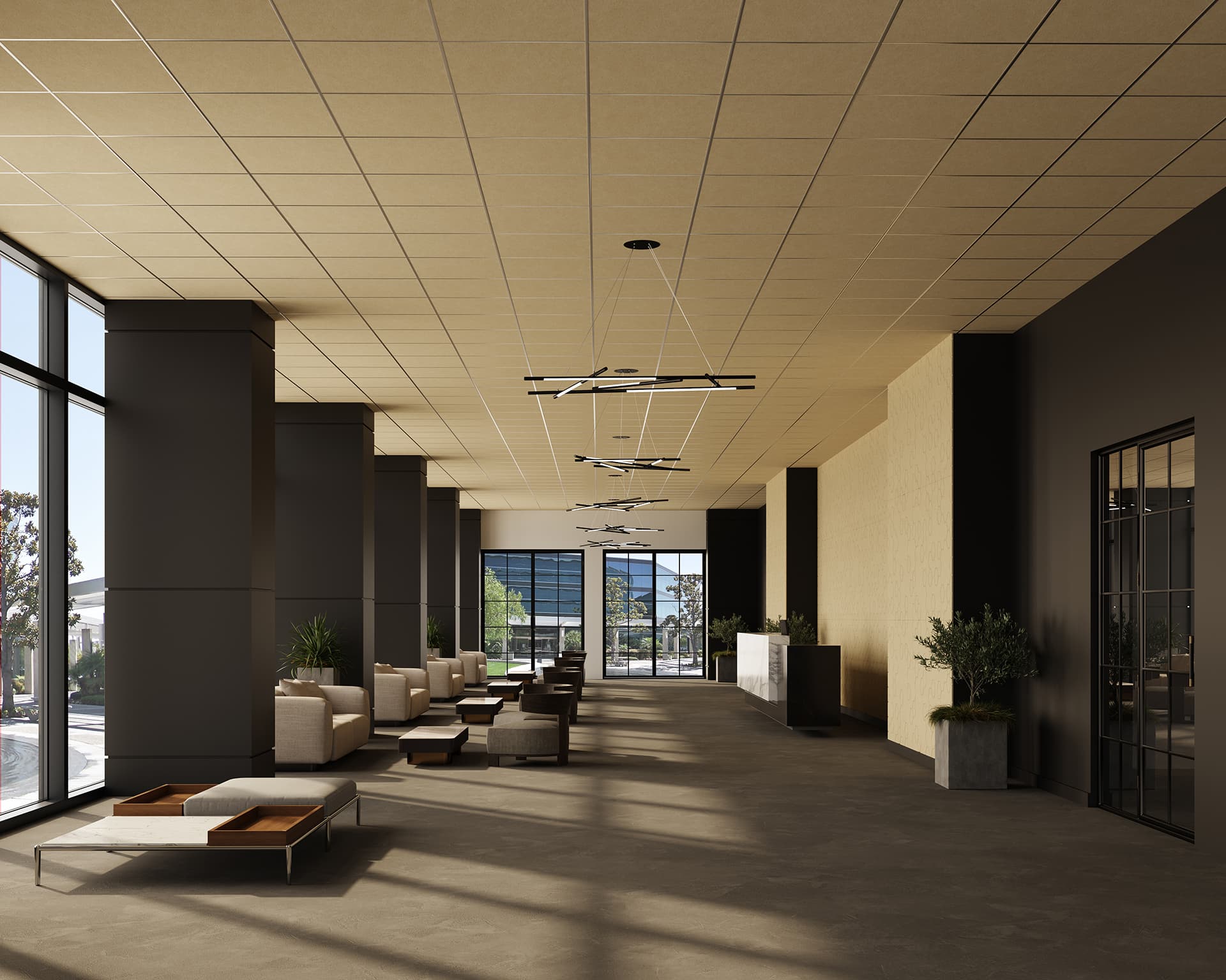 A spacious, modern lobby with large floor-to-ceiling windows allowing abundant natural light. The seating area features stylish, comfortable chairs and sofas. Potted plants add a touch of greenery, and sleek lighting fixtures hang from the ceiling.