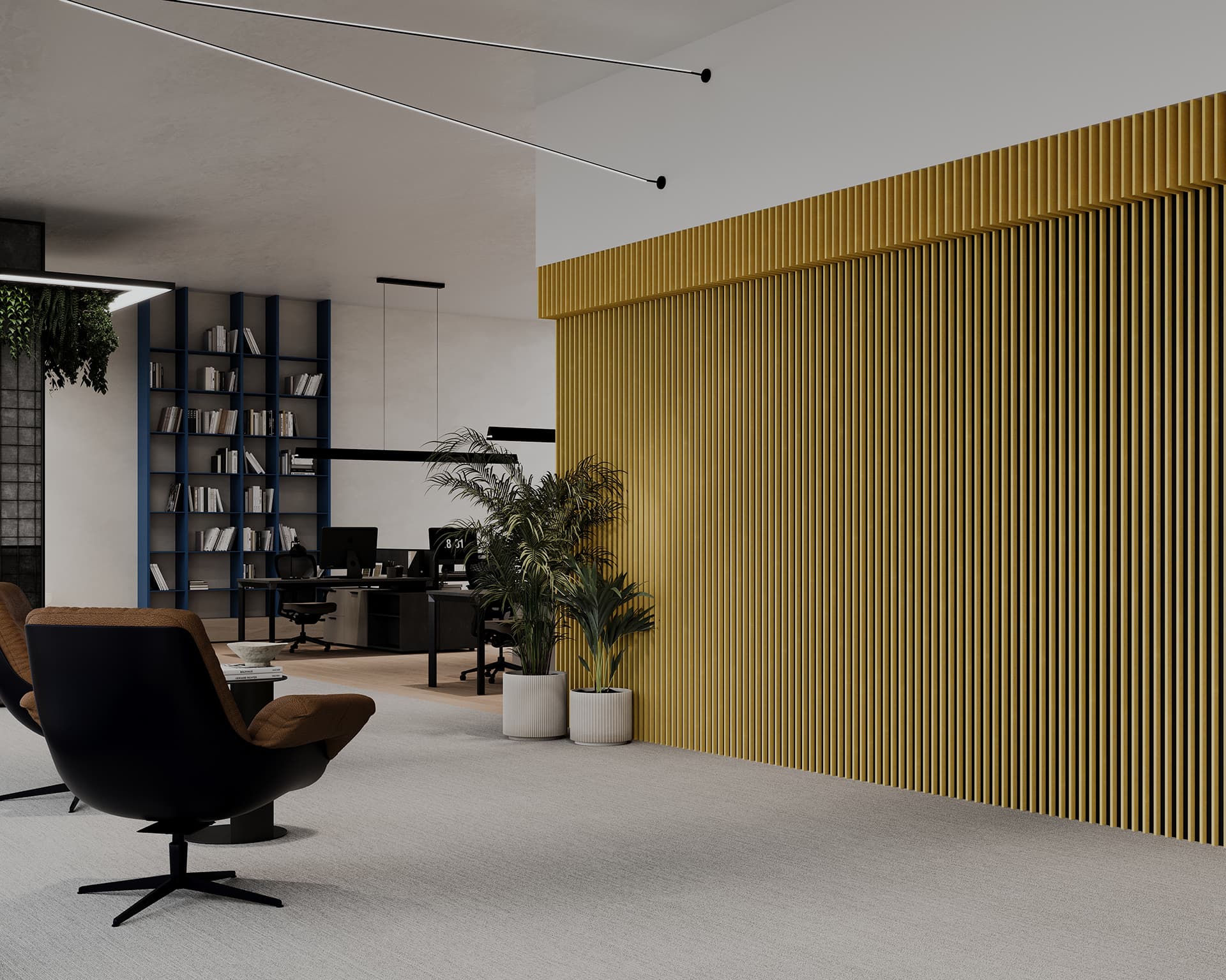 Modern office interior featuring a sitting area with a black swivel chair, potted plants, and a wall with vertical acoustic felt panels. In the background, desks with computers and a blue shelving unit full of books are visible. The space is well-lit and open.