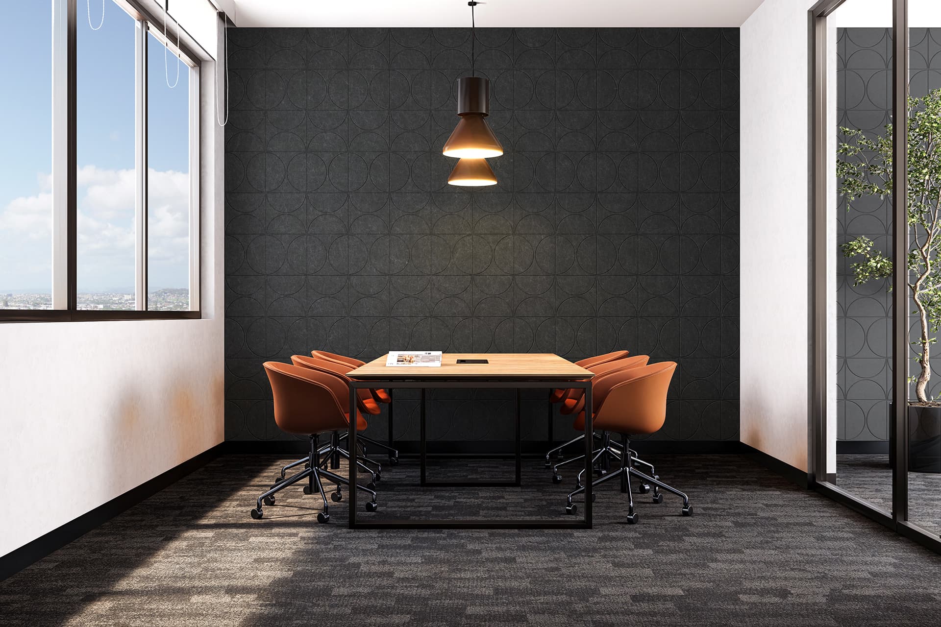 A modern conference room features a rectangular wooden table surrounded by six orange chairs. A pendant light hangs above the table, and large windows on the left showcase a bright, sunny day. The room has a dark patterned acoustic felt accent wall and glass partitions.