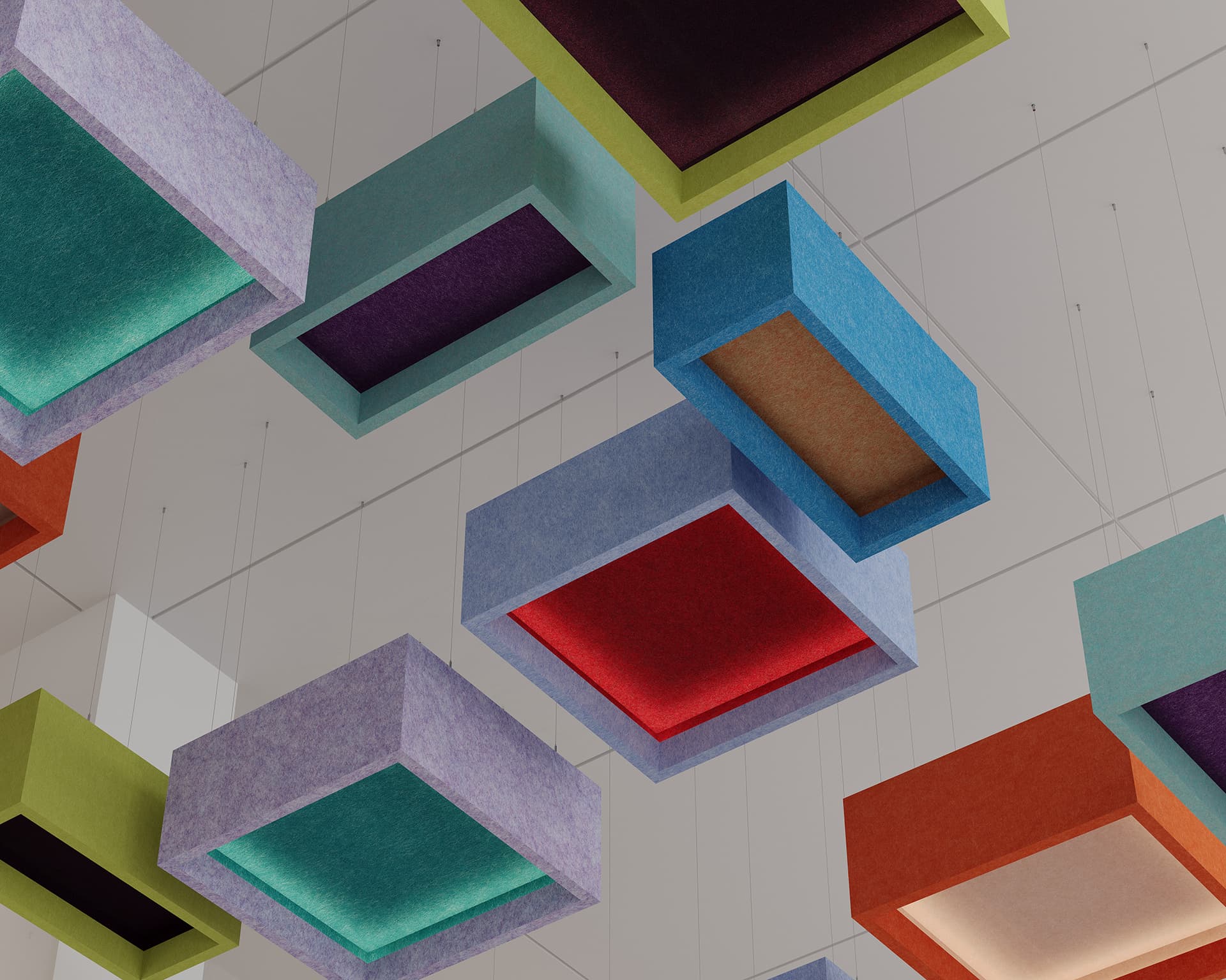 A ceiling installation featuring multiple suspended, acoustic felt rectangular boxes of various bright colors, including red, blue, green, and purple. The boxes are open on two sides, creating a visually dynamic and geometric pattern against a white ceiling background.